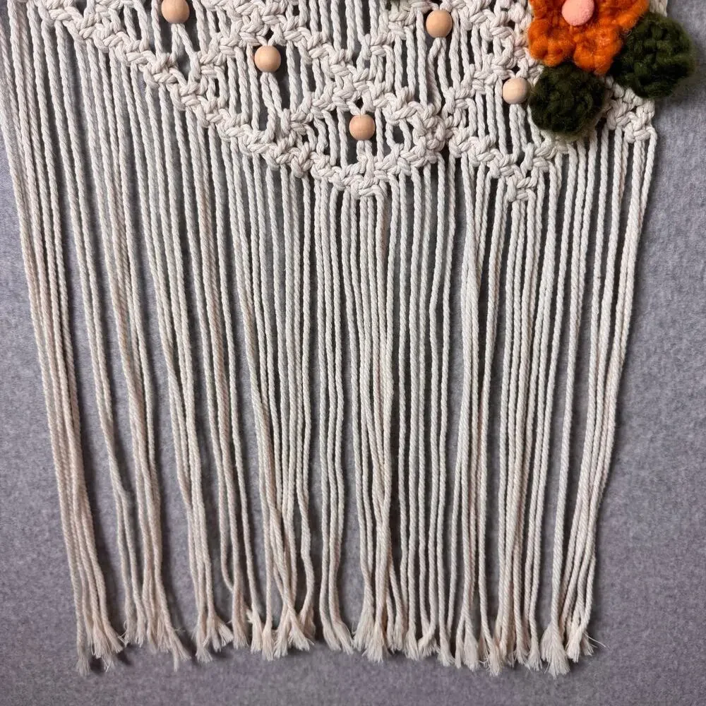 handmade boho-style macramé wall hanging crocheted flowers wooden beads fringe